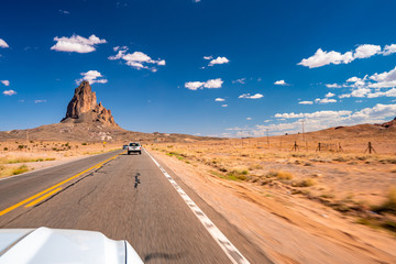 Monument Valley, USA. July 10, 2018. White Ford Mustang GT driving through the heart of the...