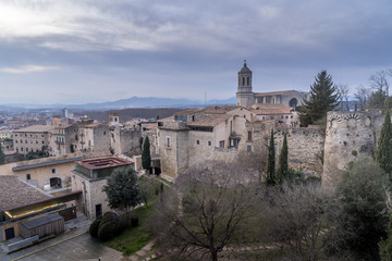 Fototapeta na wymiar Aerial panorama view of medieval Girona with Gothic St Mary Roman Catholic cathedral, city walls and colorful houses at sunset in Girona Catalonia Spain