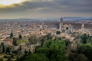 Fototapeta na wymiar Aerial panorama view of medieval Girona with Gothic St Mary Roman Catholic cathedral, city walls and colorful houses at sunset in Girona Catalonia Spain