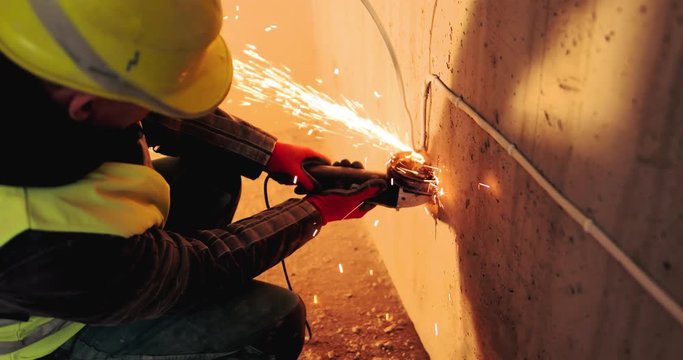 Man work with blacksmith or welder with grinding smooths steel and iron