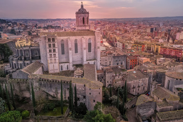 Obraz premium Aerial panorama view of medieval Girona with Gothic St Mary Roman Catholic cathedral, city walls and colorful houses at sunset in Girona Catalonia Spain