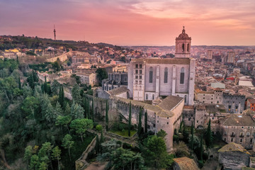 Obraz premium Aerial panorama view of medieval Girona with Gothic St Mary Roman Catholic cathedral, city walls and colorful houses at sunset in Girona Catalonia Spain