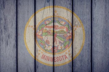 USA Politics News Concept: US State Minnesota Flag Wooden Fence
