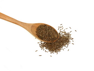 Cumin seeds or caraway in a wooden spoon isolated on white background