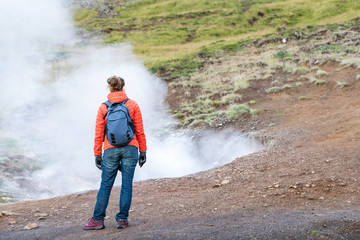 Reykjadalur, Iceland Hveragerdi Hot Springs road footpath with steam fumarole vent during autumn day in golden circle with people woman girl standing on hiking trail © Andriy Blokhin
