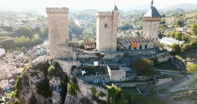 Aerial view of impressive medieval castle on rocky outcrop in French commune of Foix