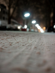 Close up shot of snowy street with tire marks