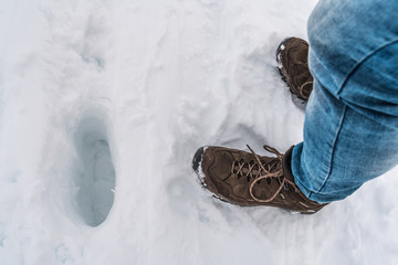 Schuhe auf einer dicken Schneeschicht mit Fußspuren