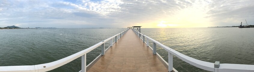 Fototapeta na wymiar Bridge sea beyond frointier sunset