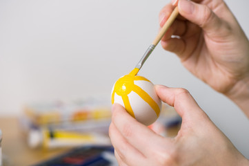 Painting easter eggs. Selective focus and shallow depth of field.