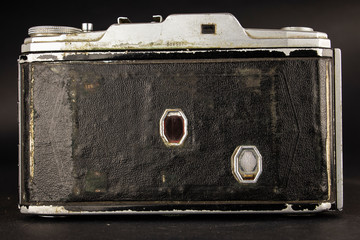 Bellows analogue camera on the black background and it like vintage or retro concept.