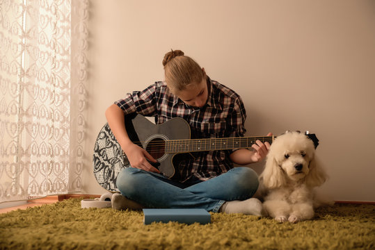 Teenager  plays guitar