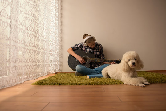 Teenager  plays guitar