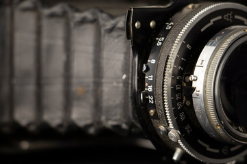 Bellows analogue camera on the black background and it like vintage or retro concept.