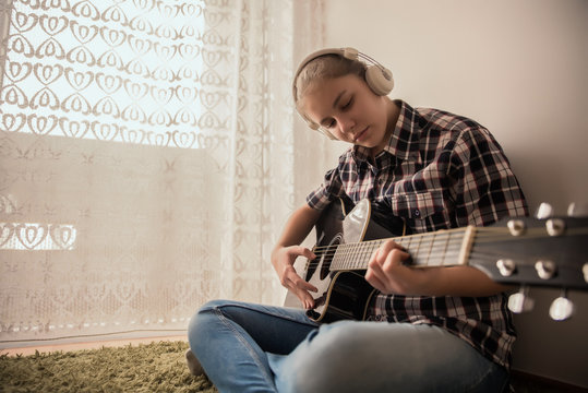 Teenager  plays guitar