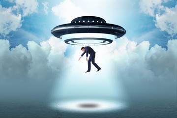 Flying saucer abducting young businessman 