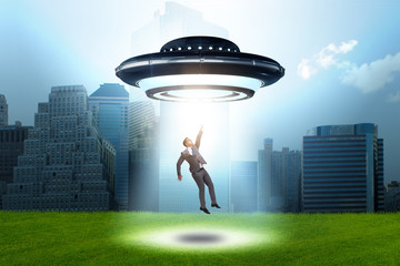 Flying saucer abducting young businessman 