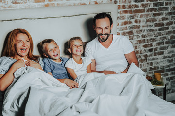 Parents and children watching funny movie together