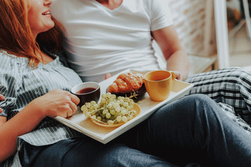 Happy man and woman having breakfast together