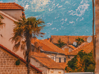 Montenegro, Herceg Novi. Tiled roofs of old town at background of the Adriatic Sea, mountains, cruise liner.