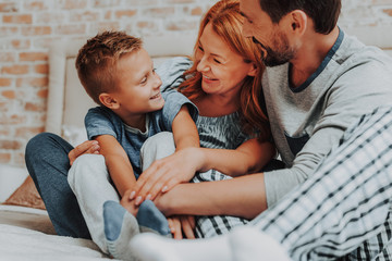 Happy morning with smiling family together in bed
