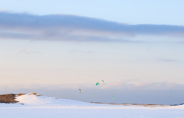Winter time, snow shore, Russia, landscape of beautiful wild nature of north sees. Beautiful snow winter ice and cold landscape, picturesque view with mountains on horizon, sky clouds, sun lens flare
