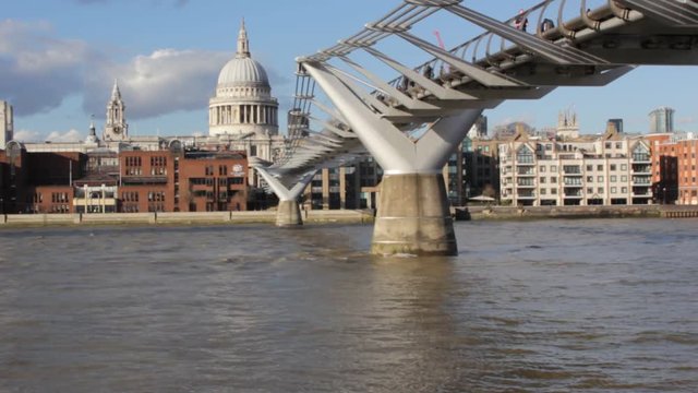st. Pauls Cathedral & Millenium bridge time lapse  view across the Thames river London, England, UK footage film video of river ripple s and people walking over the bridge both are popular tourist/tou