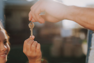 Close up of a key in hands of a loving father