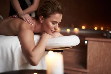 Wall murals Spa Relaxed young lady having massage in spa salon