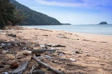 Garbage in the ocean sea.Empty used dirty plastic bottles. Dirty sea sandy shore the Sea. Environmental pollution. Ecological problem. Moving waves in the background