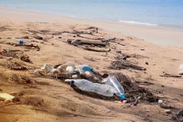 Garbage in the ocean sea.Empty used dirty plastic bottles. Dirty sea sandy shore the Sea. Environmental pollution. Ecological problem. Moving waves in the background
