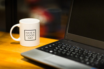 office desk. cup of coffee and laptop.
