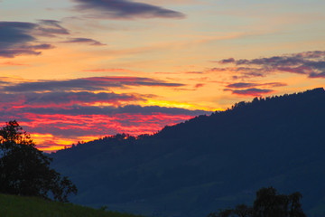 The most beautiful sunset in Switzerland, the sky is bright with bright, orange, yellow bright colors, late summer evening.