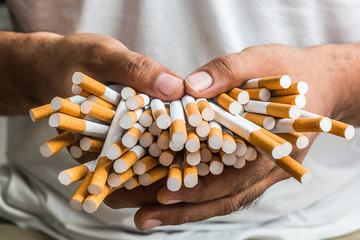 Close up Hand Holding the a lot of cigarette. © Nopphon