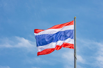Flag of Thailand on the pole and bright blue sky.
