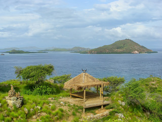Small hut on a hill at Kanawa Island in Flores Sea, Nusa Tenggara, Indonesia