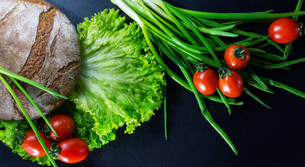 Bread, lettuce, onions and tomatoes. Healthy breakfast - top view.