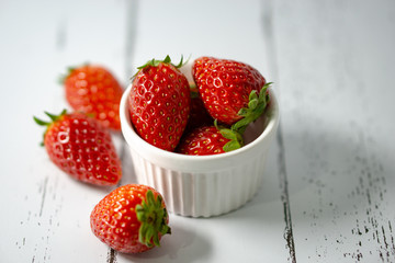 Strawberry in a bowl isolated on white background. Selective focus.