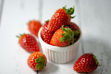 Strawberry in a bowl isolated on white background. Selective focus.