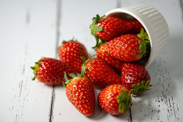 Strawberry in a bowl isolated on white background. Selective focus.