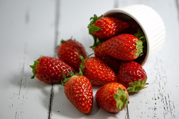 Strawberry in a bowl isolated on white background. Selective focus.