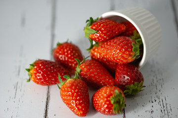 Strawberry in a bowl isolated on white background. Selective focus.