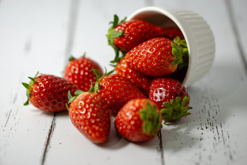 Strawberry in a bowl isolated on white background. Selective focus.