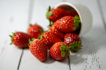 Strawberry in a bowl isolated on white background. Selective focus.