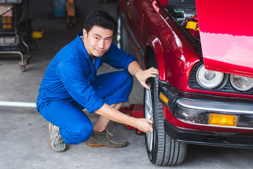 Mechanic checking the wheels of car And is about to change tires - Image