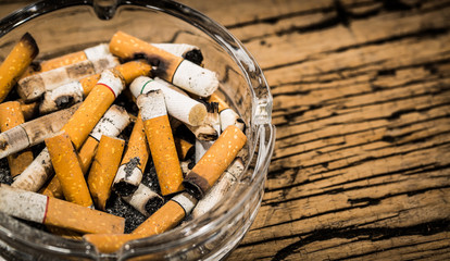 Butt cigarettes of in ashtray on table.