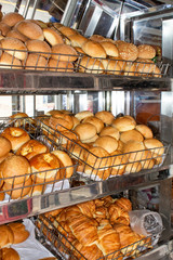 Freshly baked bread, shelves with buns on the display case. Quito, Ecuador