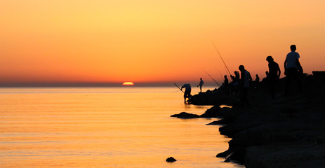 Fishermen on the seashore, the sun is rising