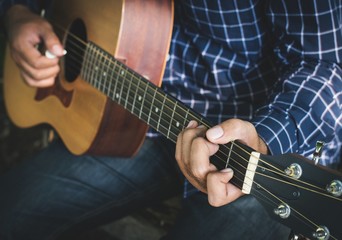 Close up musician playing guitar.