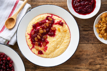 Corn porridge with cranberry jam and raisins